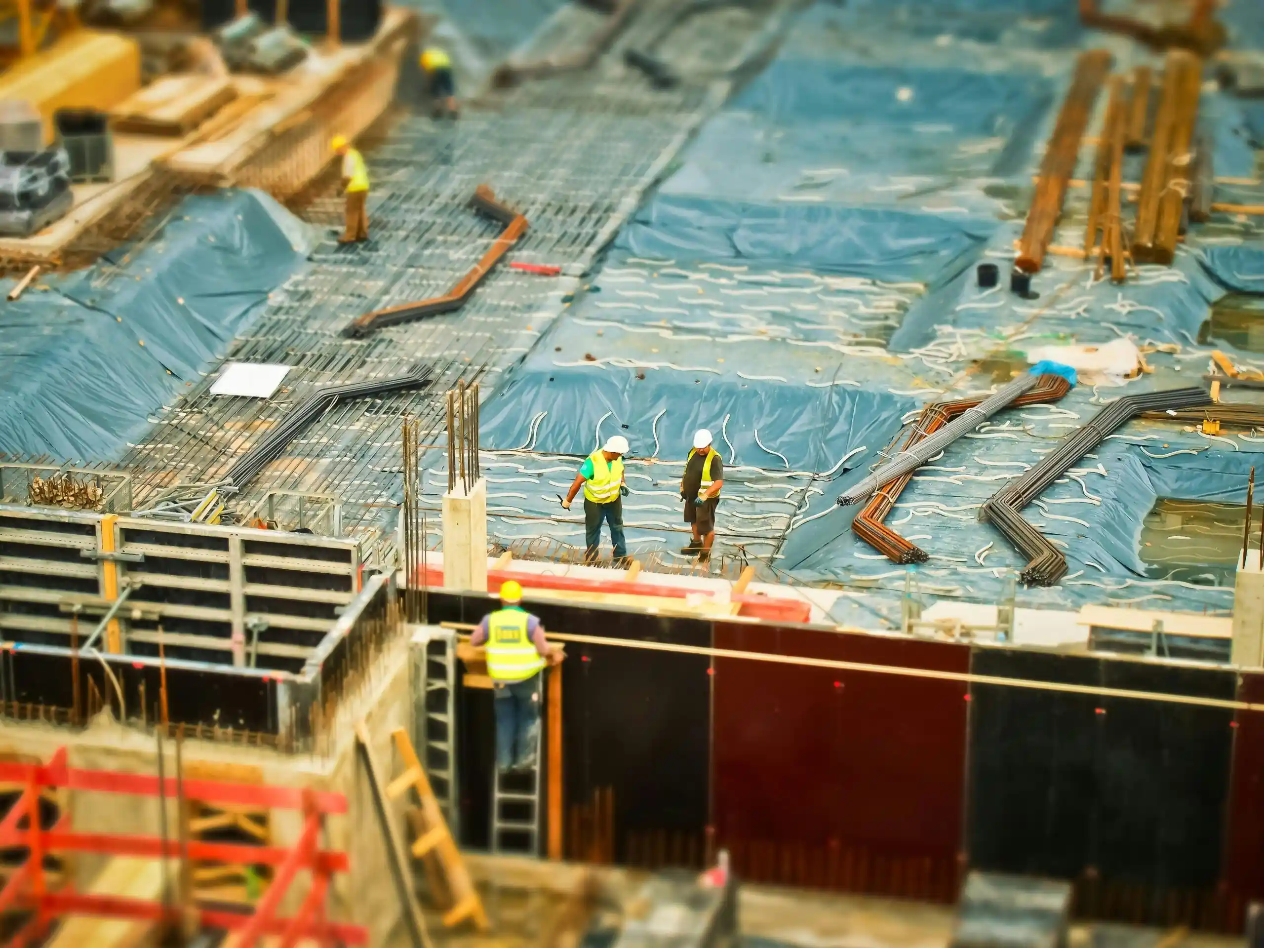 High-angle view of construction workers on a building site, engaging in construction work.