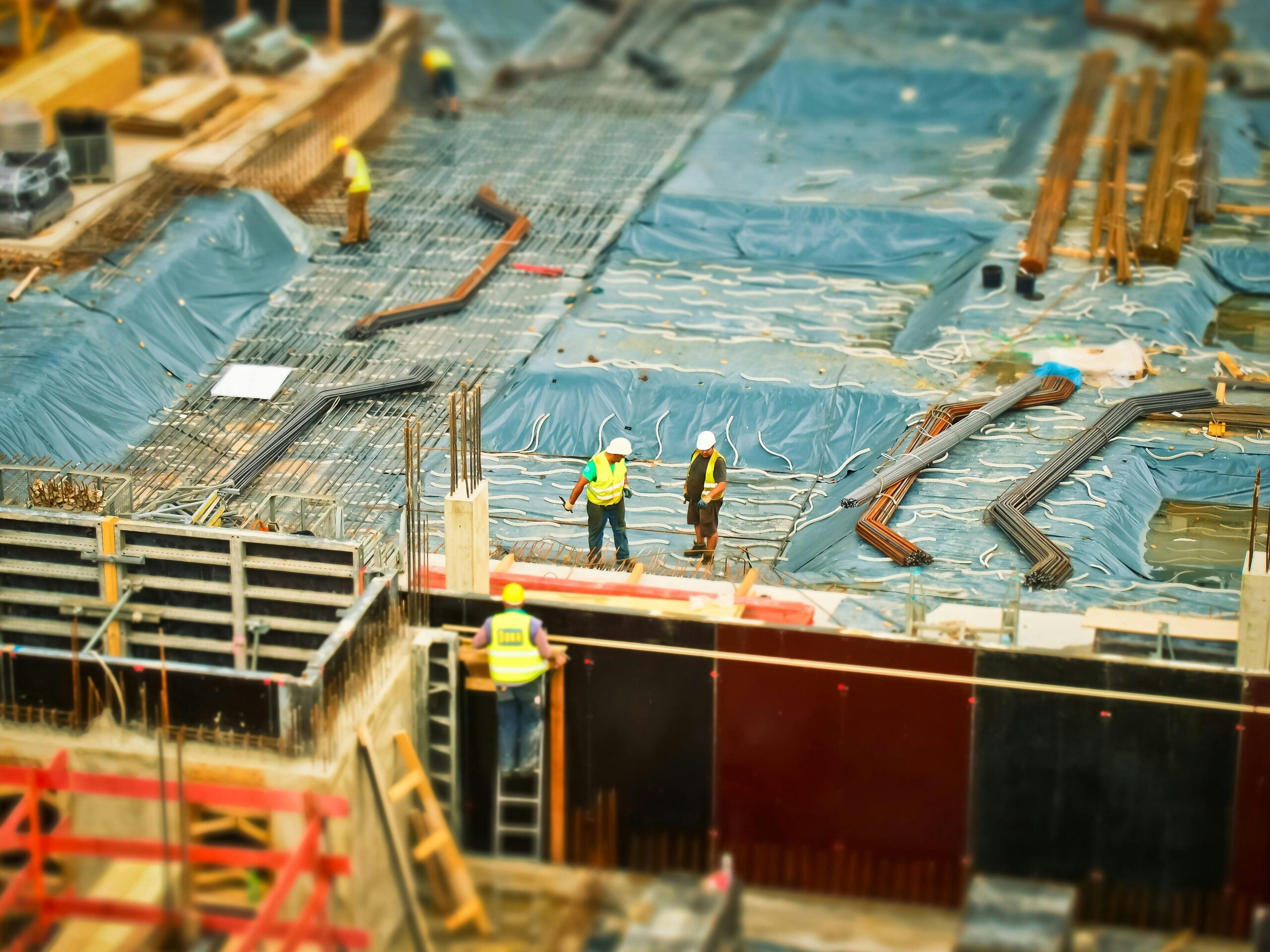High-angle view of construction workers on a building site, engaging in construction work.